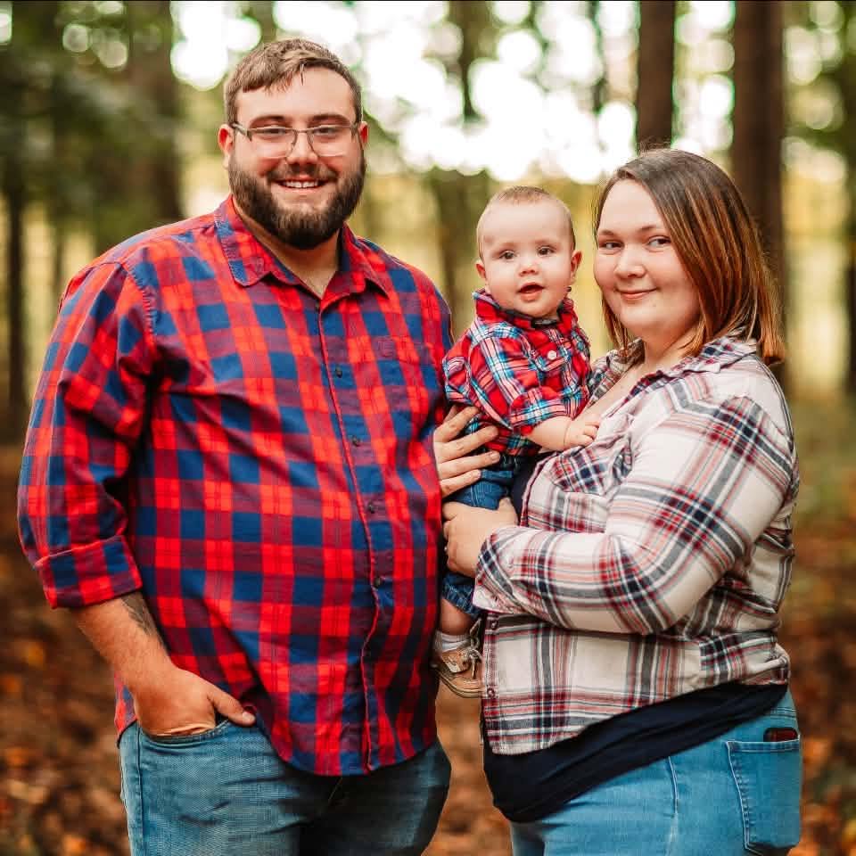 Picture of Rafe, Caleigh and their son.